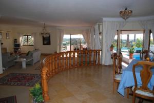 a living room with a stairway leading to a living room at Genies Villa Boutique Algarve in Almancil