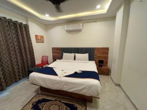 En eller flere senge i et værelse på Hotel MD Star