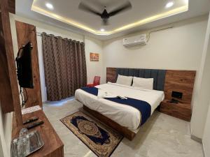 En eller flere senge i et værelse på Hotel MD Star