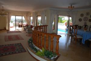 a living room with a staircase and a table and chairs at Genies Villa Boutique Algarve in Almancil +37 photos