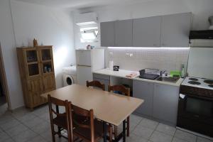 a kitchen with a table and chairs and a stove at Kritharistra Home in Vlakhiá