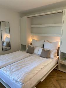 a large bed in a room with a mirror at Seenland-Studio I 75 qm I Boxspringbett I Garten I Luxus-Bad in Spalt