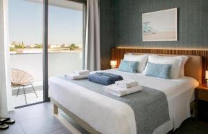 una camera da letto con un letto grande con asciugamani sopra di Magnificent Protaras Villa Villa Chelsea 3 Bedrooms Private Outdoor Pool a Protaras