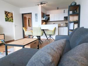 a living room with a couch and a table at Ferienpark Geyersberg inklusive aktivCARD Bayerischer Wald in Freyung