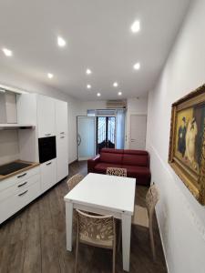 a kitchen and living room with a table and a couch at Casa Borgo&Mare - Barletta in Barletta