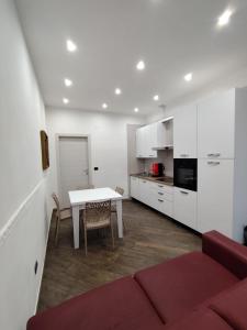 a living room with a table and a kitchen at Casa Borgo&Mare - Barletta in Barletta +6 photos