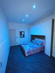 a bedroom with a large bed in a white room at Casa Borgo&Mare - Barletta in Barletta
