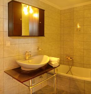 a bathroom with a sink and a bath tub at Diaporos Hotel in Vourvourou