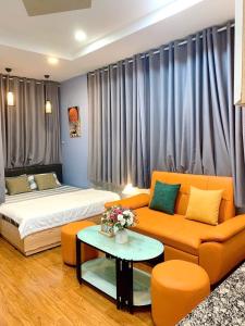 a living room with a bed and a couch at Helen Home in Ho Chi Minh City