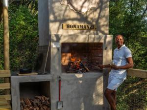 a man standing in front of a brick oven at AfriCamps at Bonamanzi Game Reserve in Hluhluwe