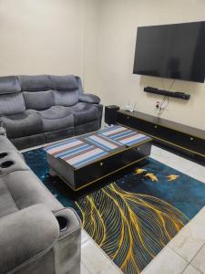 a living room with a couch and a flat screen tv at Lulu house in Mombasa