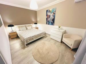 a bedroom with a bed and a chair and a rug at Villa Seba Sicily in Augusta +72 photos