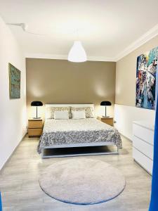 a bedroom with a large bed and two lamps at Villa Seba Sicily in Augusta