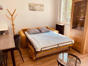 a bedroom with a bed and a glass table at Le Nid des Charmettes in Saint-Josse +15 photos