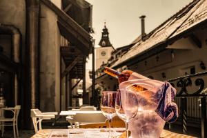 a bottle of wine sitting on a table with two wine glasses at Casa Wagner in Braşov