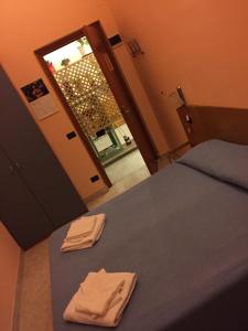 a bedroom with a bed with two towels on it at Hotel Euro in Genoa