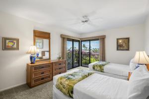a bedroom with two beds and a window at Wailea Elua 808 - Scenic Ocean Views, Classic Wailea Charm, Central AC, Wi-Fi in Wailea +82 photos
