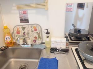 a kitchen sink with a dish drying rack and a pan at 3F 3 minutes walk from Nishi-Oi Station, Shinagawa Ward, 4 stations available, surrounded by commercial streets, rich life, convenient transportation in Tokyo