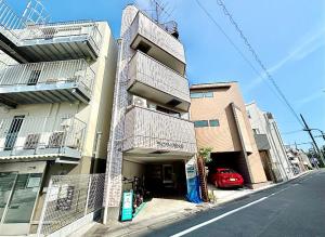 a building with balconies on the side of a street at 3F 3 minutes walk from Nishi-Oi Station, Shinagawa Ward, 4 stations available, surrounded by commercial streets, rich life, convenient transportation in Tokyo
