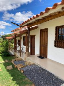 a house with a porch and a patio at Sendero de la Laja Cabaña 1 in San Gil