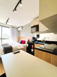 a hotel room with two beds and a kitchen at UniHome Niterói in Niterói +14 photos