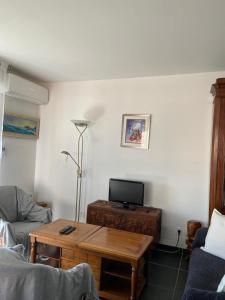sala de estar con mesa de centro y sofá en La Huperie, en Saint-Cyr-sur-Mer