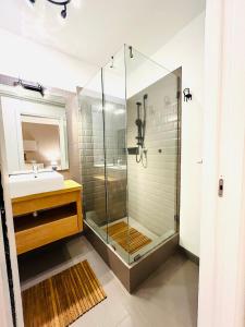 a bathroom with a glass shower and a sink at Villa Seba Sicily in Augusta