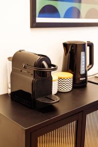 a toaster sitting on a counter next to a coffee maker at MARAL Loft München Bogenhausen in Munich