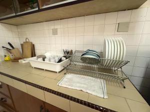 a kitchen counter with a drying rack and a sink at Spacious Comfort Stay in Seremban-5R3B 舒适温暖之家 in Seremban +39 photos