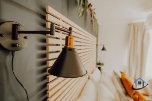 a lamp hanging on a wall next to a bed at FLAT 5 - Ground floor 2 bed apartment free parking sleeps 6 in Halesowen +41 photos