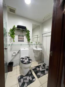 a bathroom with a toilet and a sink at Horizon 101 in Cebu City +15 photos