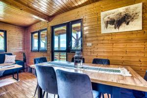 a dining room with a table and chairs at Bieszczady Żubrowe Wzgórze 785-049-543 in Stężnica