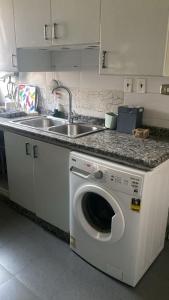 a kitchen with a washing machine and a sink at Z m abartment hotel in Giza