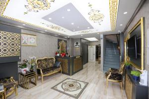a lobby with chairs and a staircase with a ceiling at Grand Moon Hotel Suites in Istanbul
