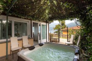 a hot tub on the patio of a house at Luxury townhouse with panoramic Como lake views by Aura Luxury Collection in Carate Urio