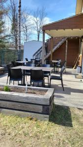 a group of tables and chairs on a patio at Motel Au Bercail in Temiscaming