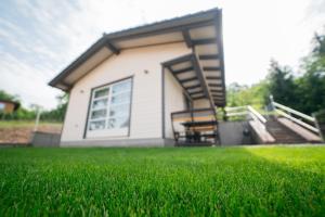 a small house with a lawn in front of it at Hedera Sovata 2 in Sovata