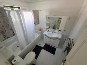 a bathroom with a sink and a toilet and a tub at mahdia old city luxury house in Mahdia +9 photos