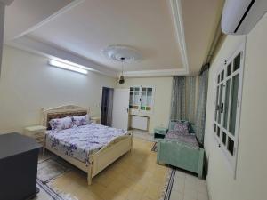 a bedroom with a bed and a chair in it at mahdia old city luxury house in Mahdia