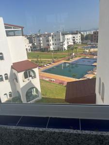 a view of a swimming pool from a building at Joli et confortable appartement in Cabo Negro