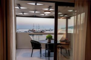 a dining room with a table and a view of a boat at Sole Mare Boutique Hotel in Zakynthos Town