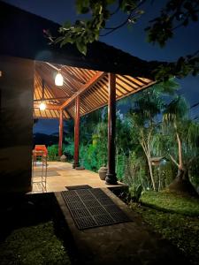 a pavilion with a table and a chair under it at Rumah Tenun in Karangasem