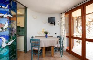 a dining room with a table and chairs at Casa Irene by Wonderful Italy in Porto Cervo