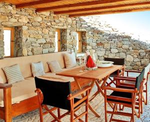 a dining room with a table and a couch at Luxury Mykonos Villa Kings And Queens Villa Private Pool Kastro in Mýkonos City