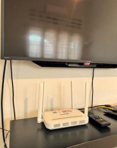 a computer monitor sitting on top of a table at Spacious Comfort Stay in Seremban-5R3B 舒适温暖之家 in Seremban