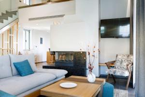 a living room with a couch and a table at Exquisite Crete Villa Villa Kleanthi 4 Bedroom Private Pool Panoramic in Stalos