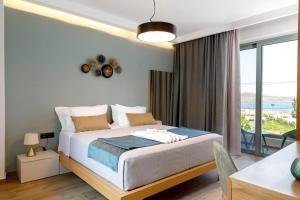 a bedroom with a bed and a large window at Exquisite Crete Villa Villa Kleanthi 4 Bedroom Private Pool Panoramic in Stalos +29 photos