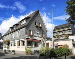 a building with a black and white building at Hetzel's Hotel in Olpe