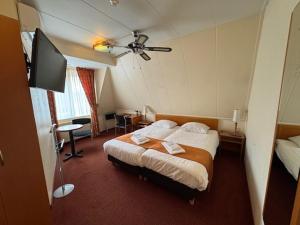 Ένα ή περισσότερα κρεβάτια σε δωμάτιο στο Hotel Kuik