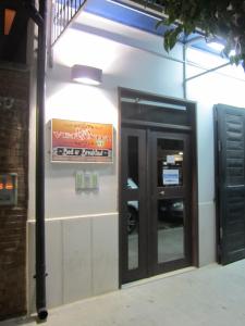 an entrance to a building with a sign on it at La Veranda in Margherita di Savoia